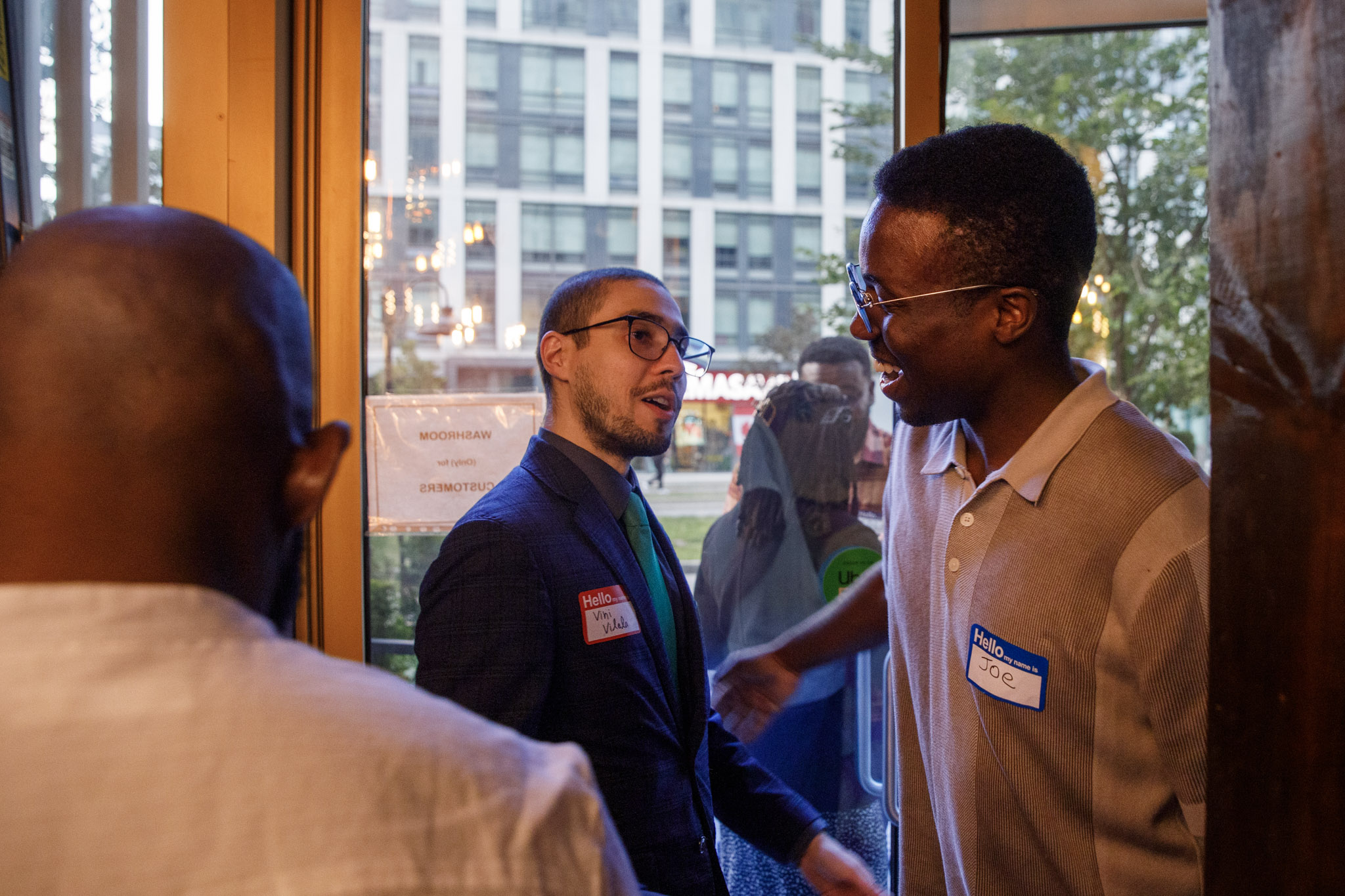 Guests greeting each other as they arrive at a networking event